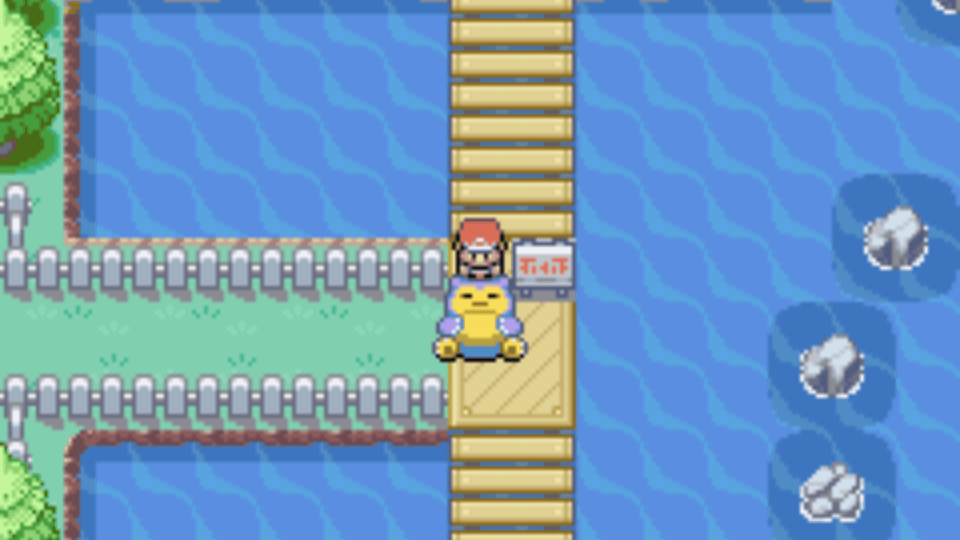 Snorlax duerme bloqueando un puente sobre el agua en Pokémon Rojo Fuego